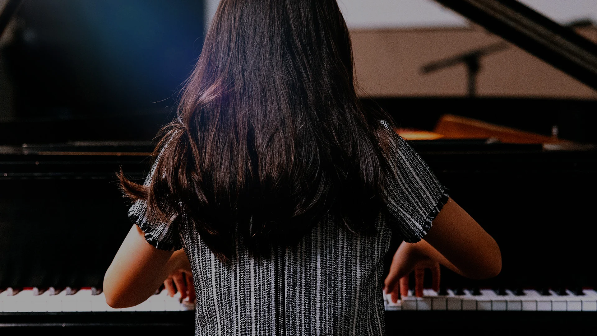 Pianist performing at a grand piano