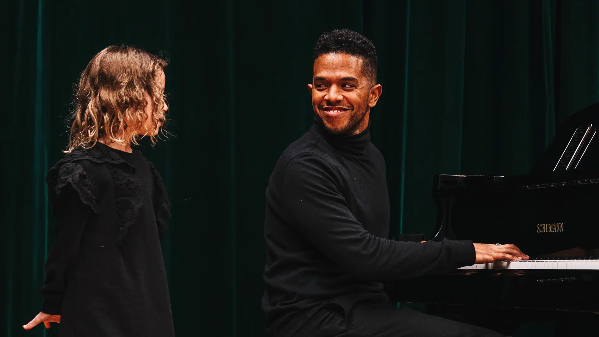 Piano teacher demonstrating technique at the keyboard