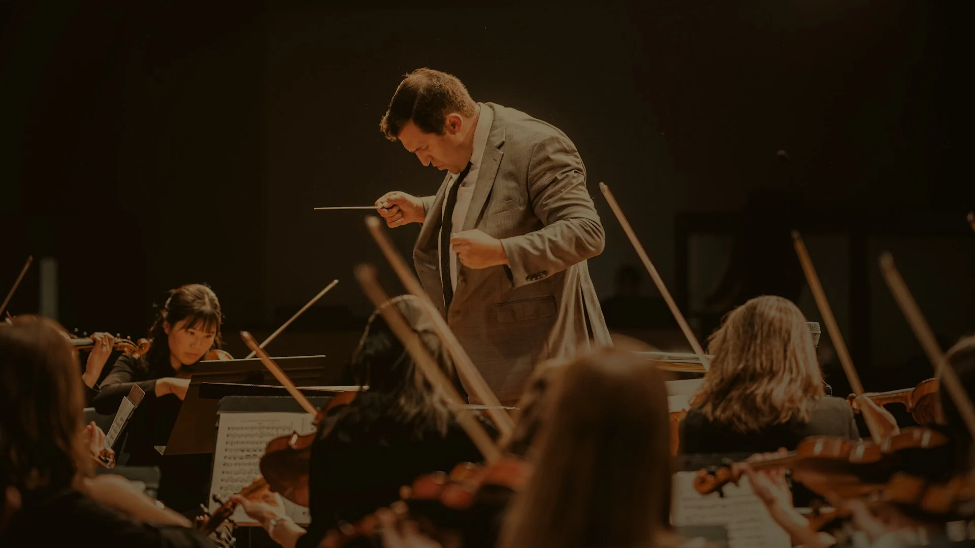 Orchestra conductor leading an ensemble