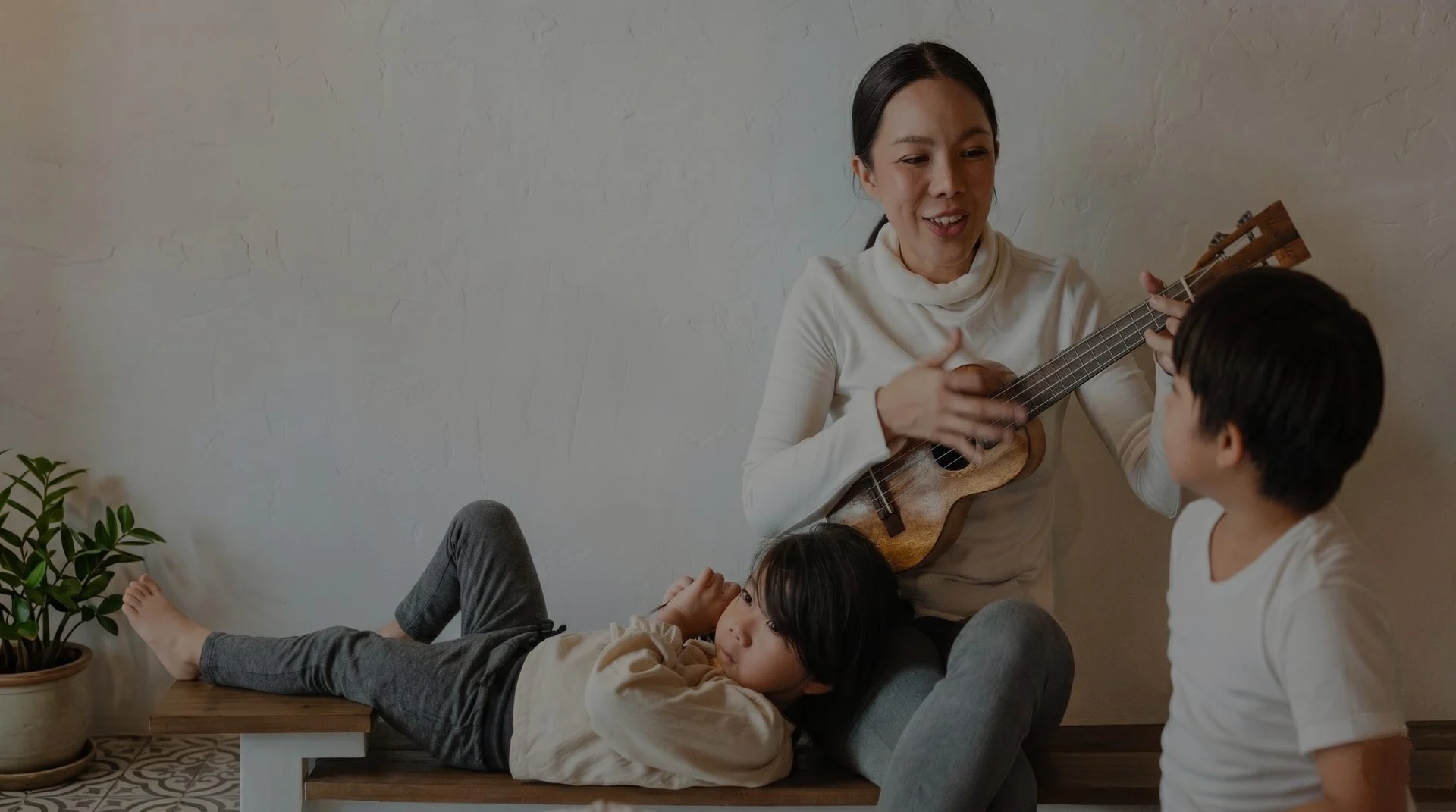 Young children enjoying a music class with caregivers