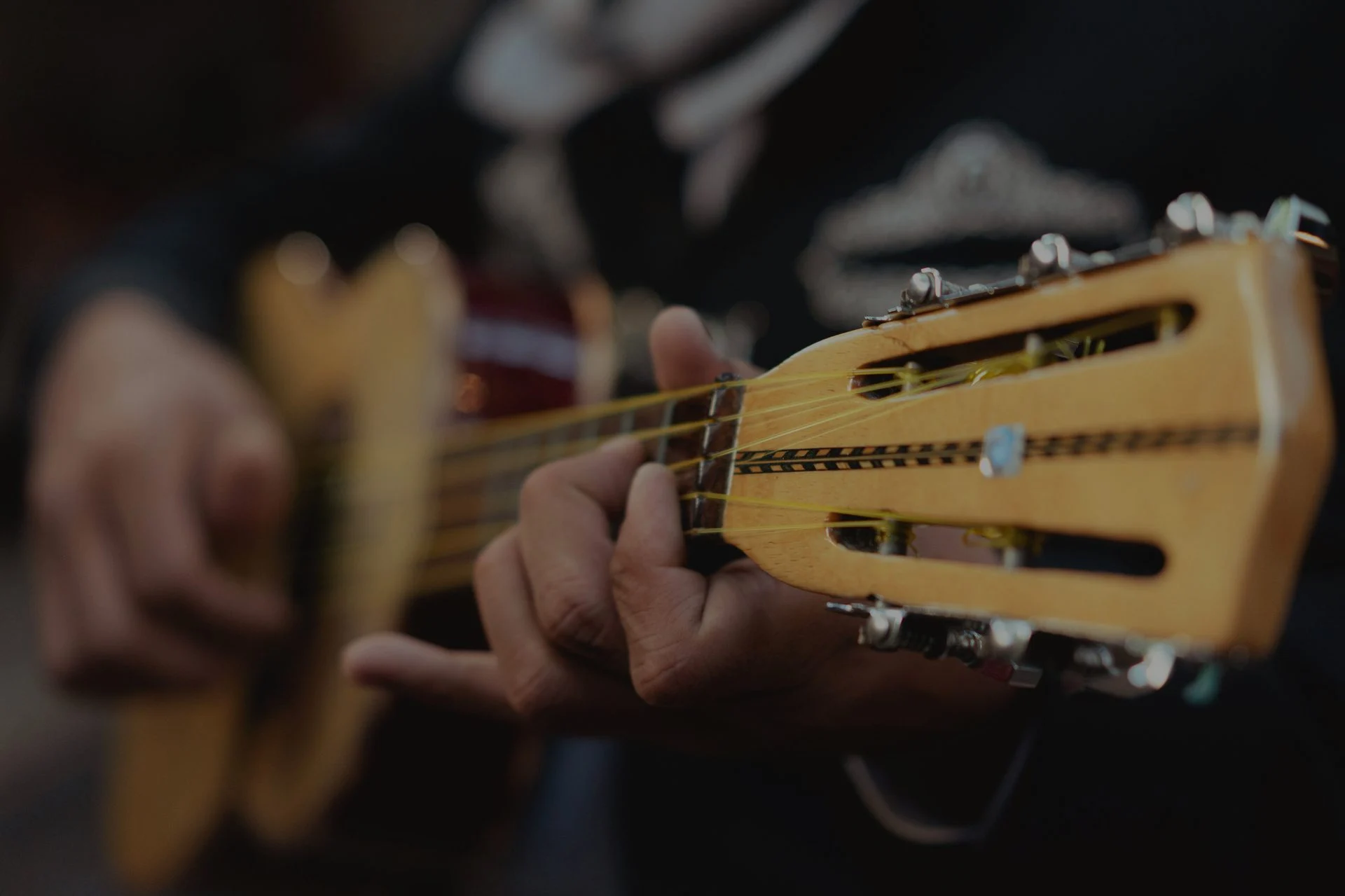 Musician performing on a mariachi vihuela