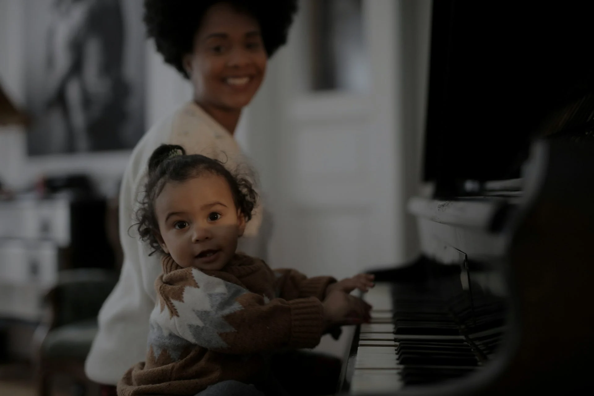 Young children enjoying a music class with caregivers