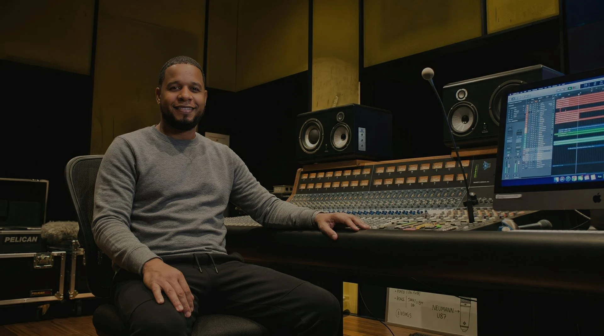 Music producer working at a studio mixing console