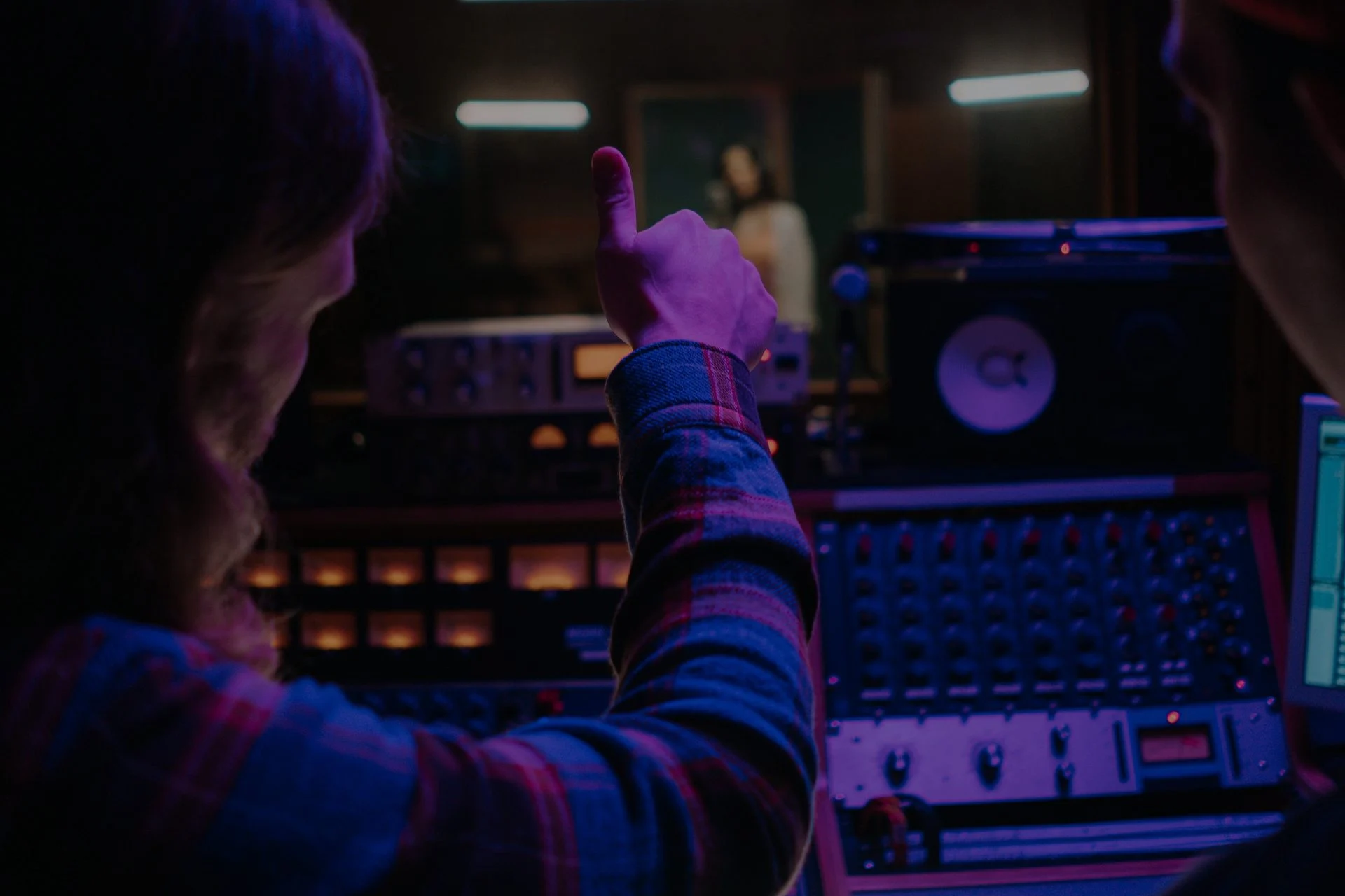 Music producer working at a studio mixing console