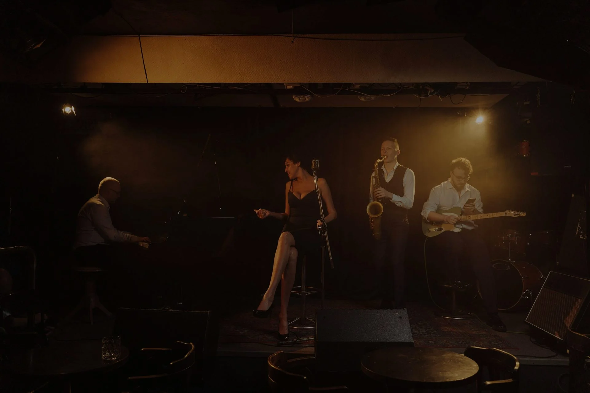 Vocalist performing with a microphone in a studio or stage setting