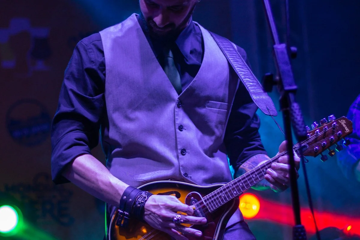 Mandolin teacher demonstrating technique for a student