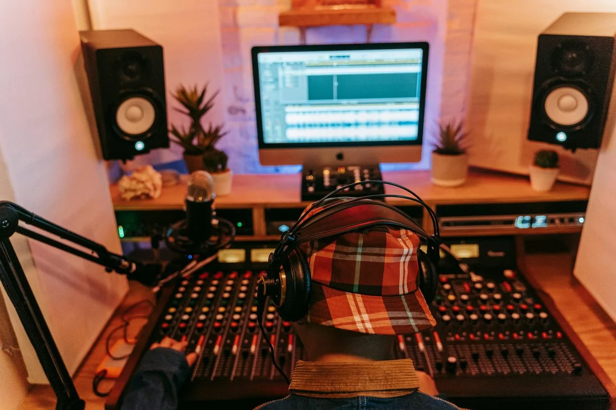 Mixing & Mastering lesson — student and instructor at a studio workstation