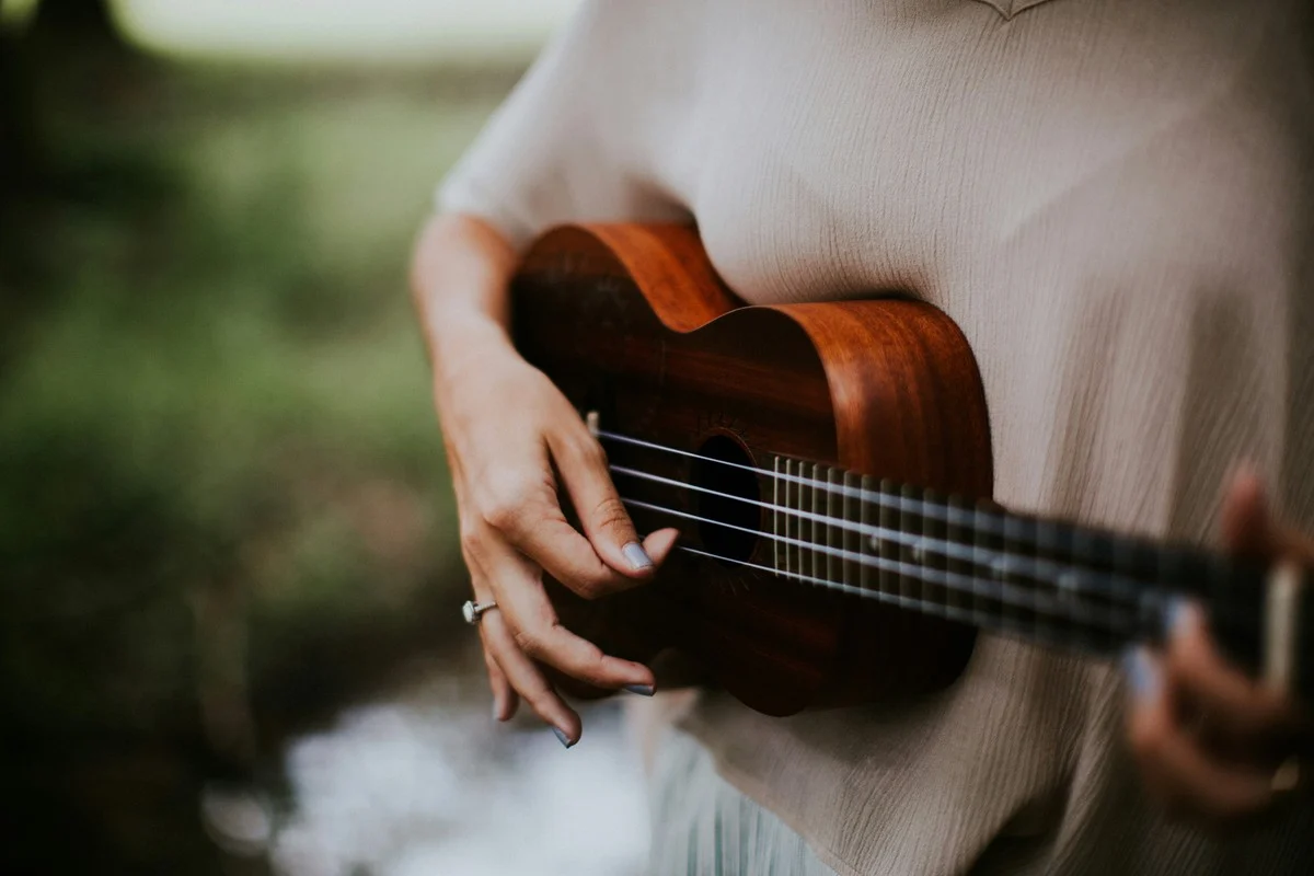 Ukulele lesson — student practicing with an instructor