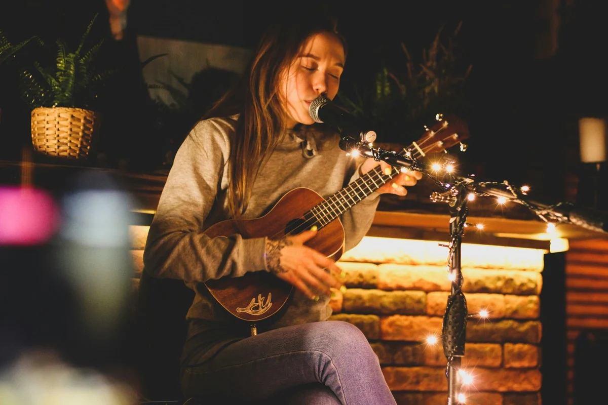 Student working through a ukulele exercise with a coach