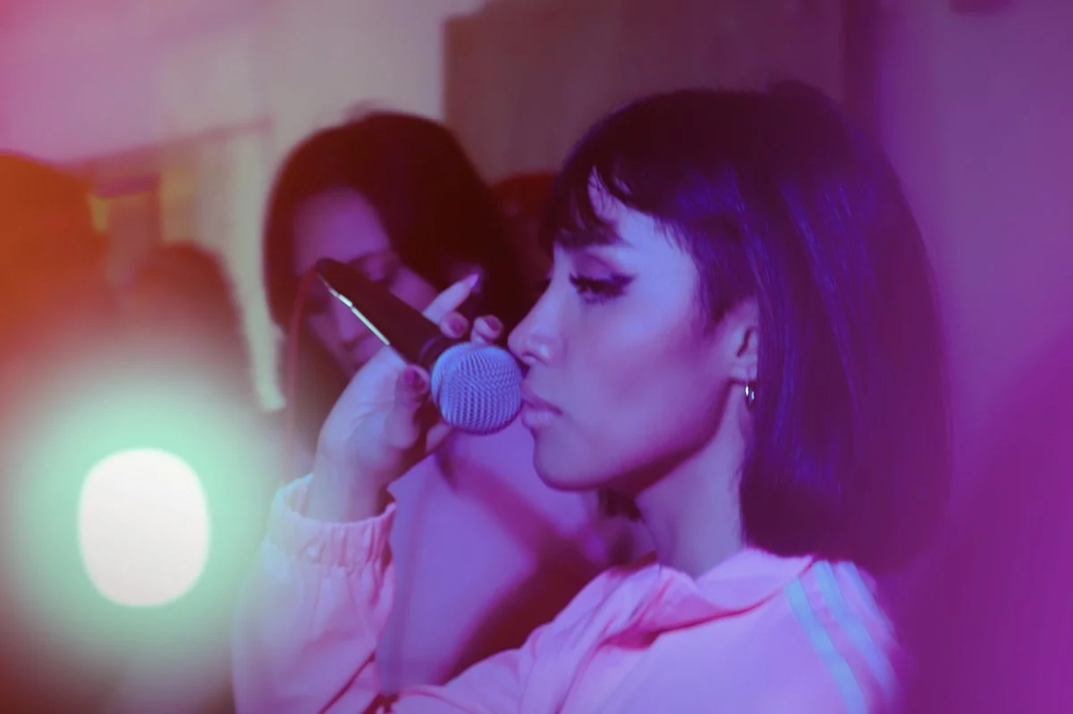 Vocal coach guiding a singer through a beatboxing exercise