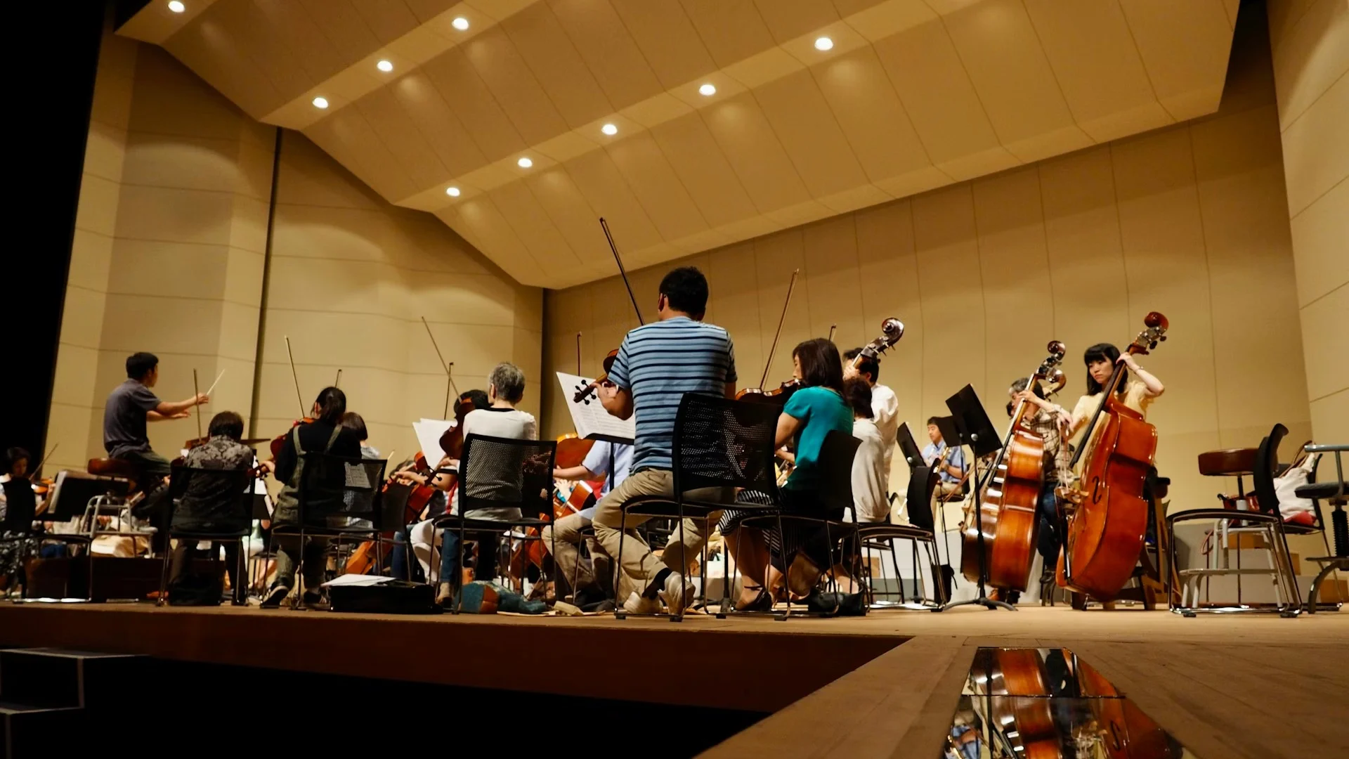 Conducting coach demonstrating baton technique to a student