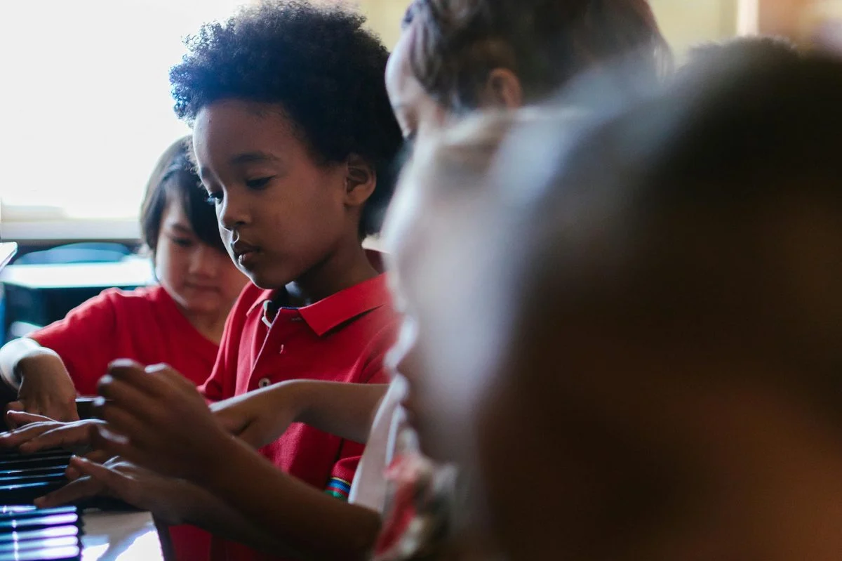 Children and caregivers singing together in an early-childhood music class
