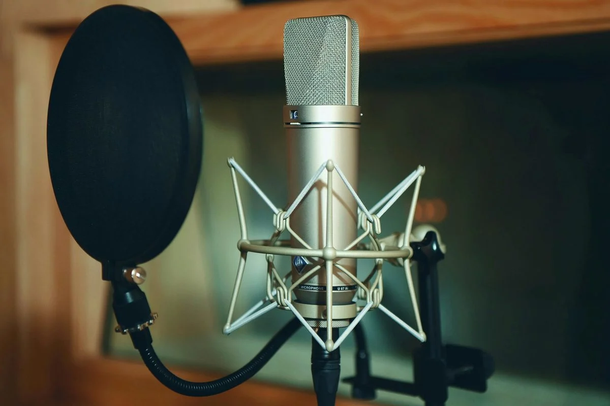 Teacher demonstrating mixing techniques on studio monitors