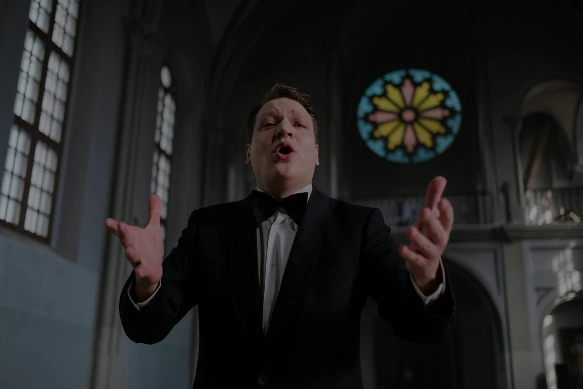 Vocal coach guiding a singer through a tenor exercise