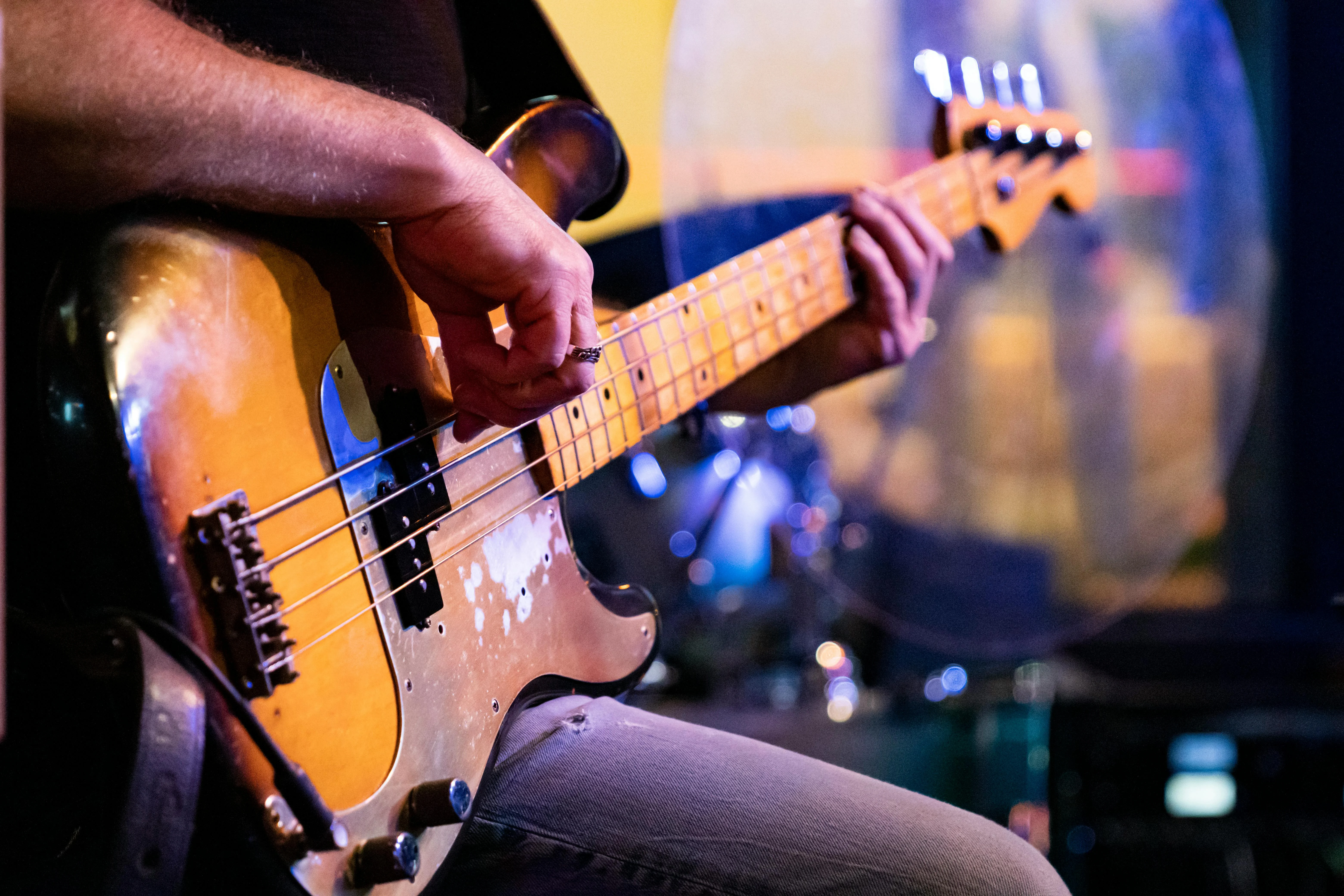 Electric Bass teacher demonstrating technique for a student