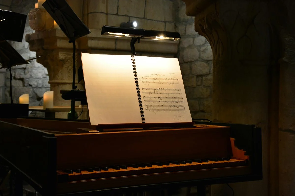 Harpsichord teacher demonstrating technique for a student