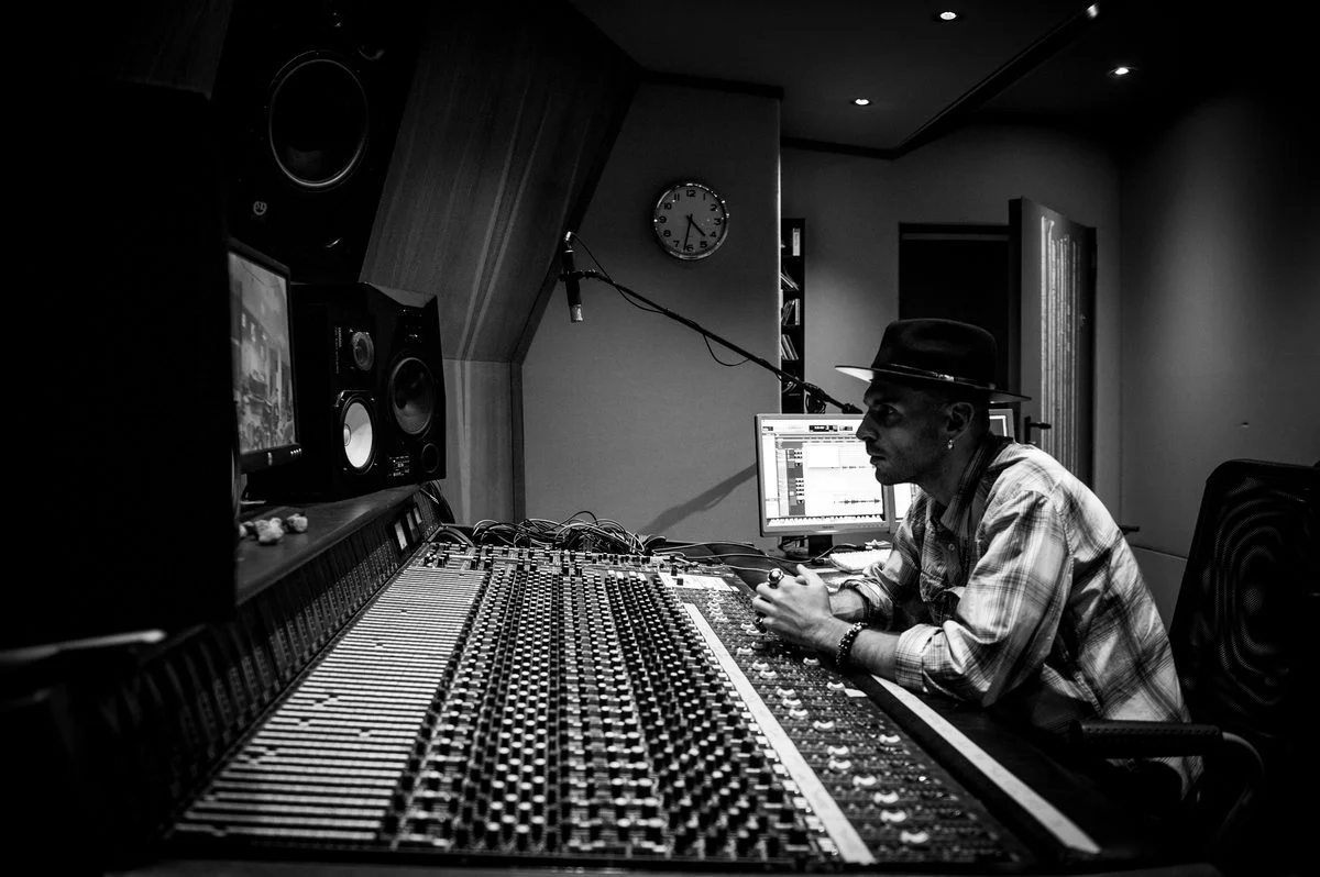 Student working on a DAW session with a producer-mentor