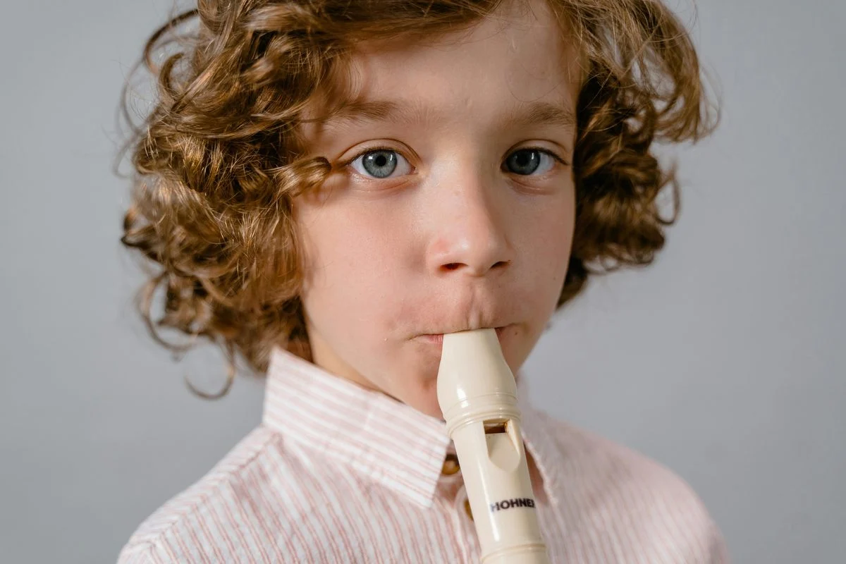 Recorder teacher demonstrating technique for a student